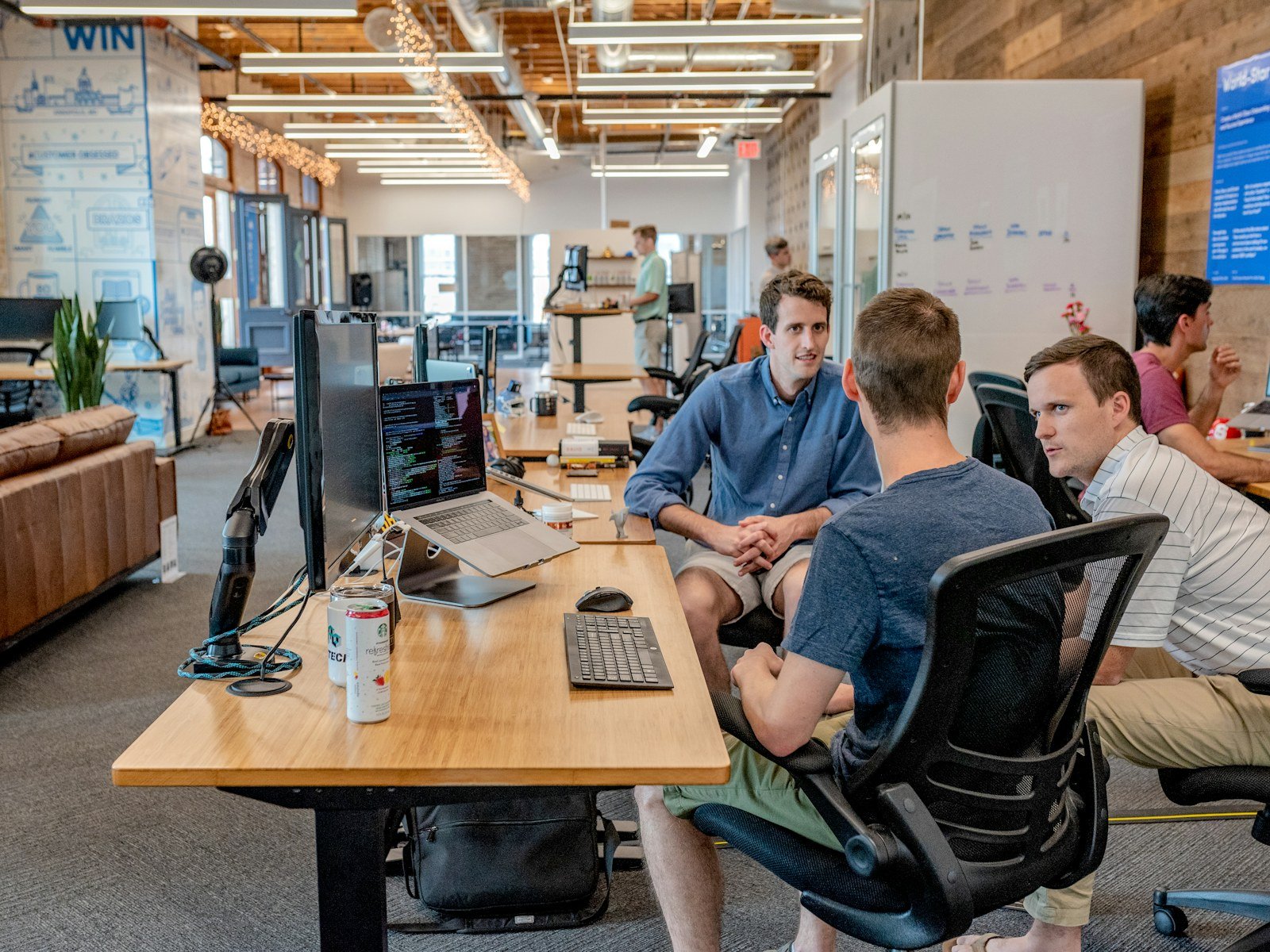 Software professionals collaborating around computers